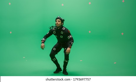 Actor Wearing Motion Caption Suit and Head Rig acts as an Animal or a Monster for CGI Green Screen Scene. Big Budget Filmmaking On Film Studio Set Shooting Blockbuster Movie with Chroma Key - Shutterstock ID 1793697757