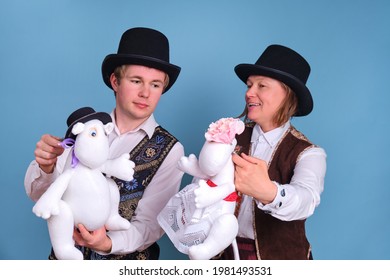 Actors with Moomin troll dolls on a blue background - Moscow, Russia, April 28, 2021