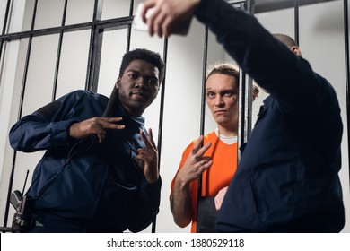 Actors on the set of a movie about prison make a funny selfie in a prison cell against the background of bars