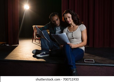 Actors Reading Their Scripts On Stage In Theatre