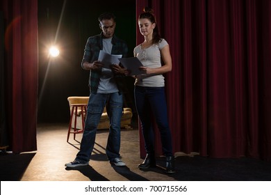 Actors Reading Their Scripts On Stage In Theatre