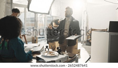 Actress, conversation and director with script in studio for feedback or instructions on film process. Discussion, production or videography with producer and talent on set for shoot direction