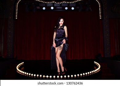 Actress On The Stage Cabaret With Red Curtains And Lamps