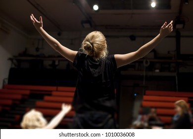 actress rehearsing in front of empty theater - Powered by Shutterstock