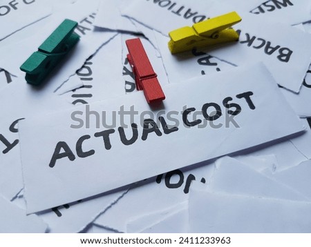 Actual cost writting on paper background.