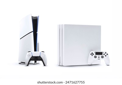 Actual game console and old generation game console on white background.