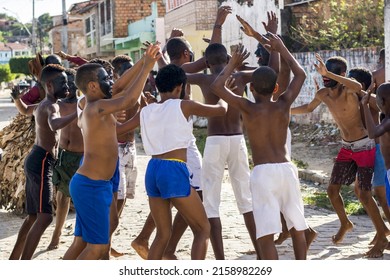 ACUPE, BRAZIL - Oct 26, 2021: A Group Of Residents Of Acupe, Santo Amaro, Bahia, Jumping With Hands Up  Struggle To End Slavery 