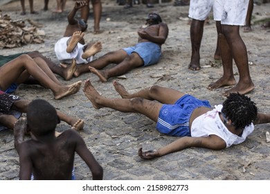 ACUPE, BRAZIL - Oct 26, 2021: A Group Of Male Residents Of Acupe, Santo Amaro,Bahia, Lying On The Ground  Struggle To End Slavery 