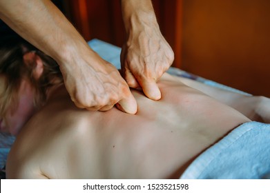 Acupressure Massage In Spa Centre. Woman At Acupressure Back Massage, Masseur's Hands Close Up. Body Therapy For Healthy Lifestyle. 