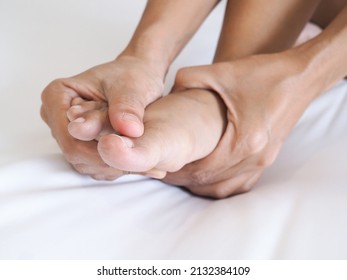 Acute Foot Pain Of Thai Asian Women And Massage On Feet To Relieve Severe Sore Feet. Medical Health Care Concept.