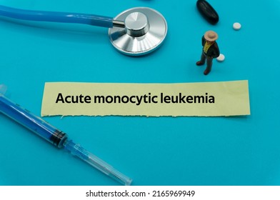 Acute Monocytic Leukemia.The Word Is Written On A Slip Of Colored Paper. Health Terms, Health Care Words, Medical Terminology. Wellness Buzzwords. Disease Acronyms.