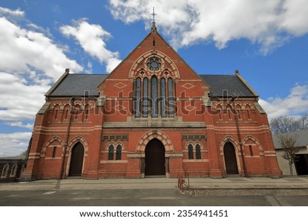 AD 1883-84 Gothic Revival style Central Uniting Church-former Wesleyan Church facade: polychrome bricks, geometric tracery elongated windows, horizontal banding, lozenge motifs. Ballarat-VIC-Australia