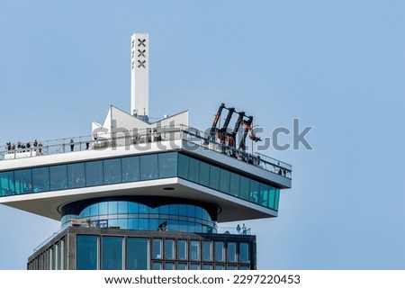 A'dam building in Amsterdam with the lookout tower, revolving restaurant and swim.  Dutch attraction for tourism and views in gorgeous sunshine with blue sky