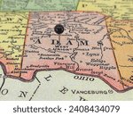 Adams County, Ohio marked by a black tack on a colorful vintage map. The county seat is located in the village of West Union, OH.
