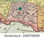 Adams County, Ohio marked by a green tack on a colorful vintage map. The county seat is located in the village of West Union, OH.