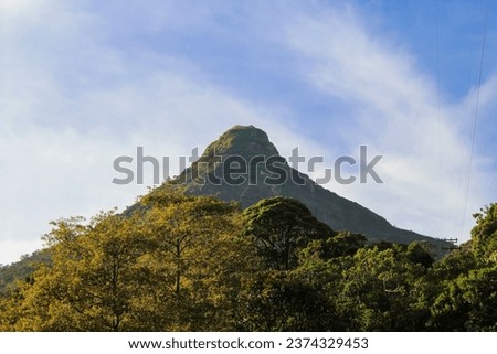 Adam's peak in Sri Lanka in the early morning after the sunrise. Blue sky with copy space for text