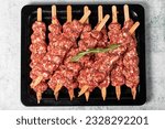 Adana kebab. Turkish raw adana kebab on gray background. Turkish cuisine delicacies. Top view