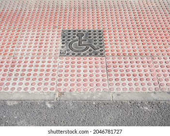 Adaptation Of A Sidewalk For The Disabled People In Front Of A Zebra Crossing, With A Handicapped Accessible Sign In The Center, Copy Space All Around.