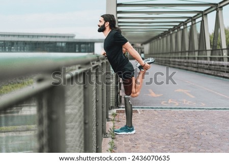 Adaptive athlete with leg prosthesis warming up on a bridge - Emphasis on determination and adaptive sports.