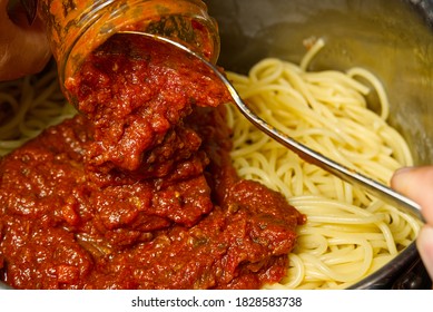 Add Bolognese Sauce On Spaghetti In Pot. Cooking Pasta Bolognese At Home