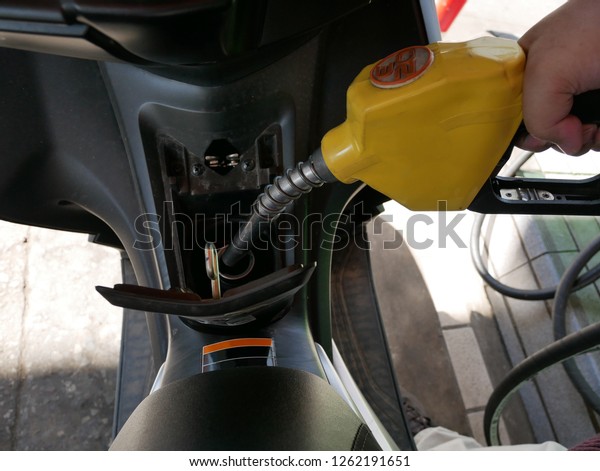 Add fuel to\
the motorcycle at a petrol station\
