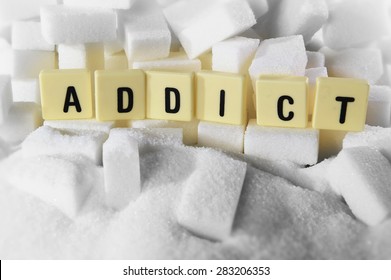 Addict Block Letters Word On Pile Of Sugar Cubes Close Up In Sugar Addiction , Sweet Nutrition , Unhealthy Eating And Diet Concept