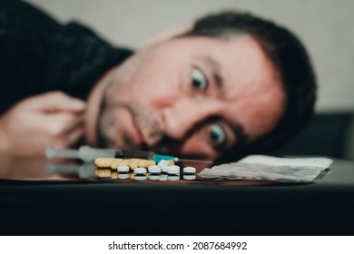 Addict, breaking, pain,depression,illness. Drug addict with crazy eyes.drug user looking dependent from different types of drugs. Drugs concept.Toned selective focus.