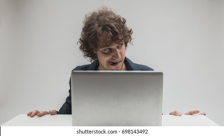 addict businessman alone sitting at office laptop watching porn or online gambling isolated on gray background on internet chat addiction concept