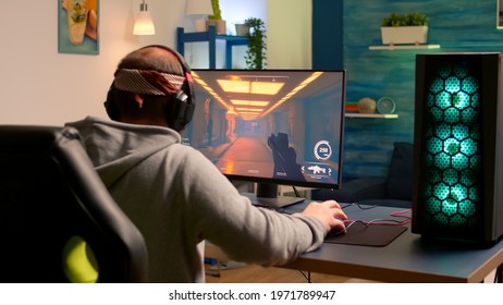 Addicted Video Game R Performing Cyber Video Games Using Professional Headphones In Gaming Room. Competitive Gamer Playing Video Game Tournament With New Graphics On Powerful Computer.