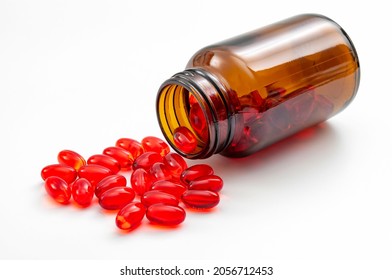 Addictive pain relief drug, oral administration therapeutic medicine and healing science concept with many spilling red prescription medication isolated on white background