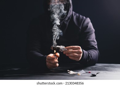 Addictjunkie man preparing drugs. The concept of crime and drug addiction.
