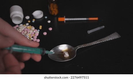 addict's table pills and injection on the black table - Shutterstock ID 2276497511