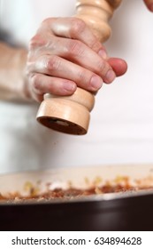 Adding black pepper using pepper mill into ground meat