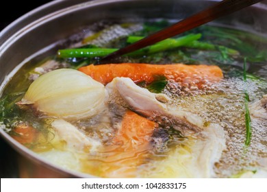 Adding Chicken Wings Into Saucepan. Cooking Chicken Broth.