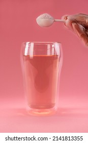 Adding Collagen Powder In A Glass Of Water. Superfood Additives. Vertical.