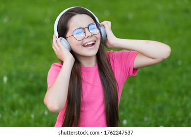 Adding Happiness Through Singing. Happy Singer Sing Song On Green Grass. Little Girl Enjoy Singing In Headphones. Singing Voice. Vocal Exercises. Summer Music. Enjoying Solo Singing.