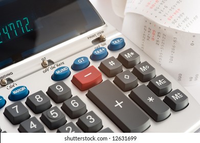 An Adding Machine Or Calculator With Adding Machine Tape Or Paper.