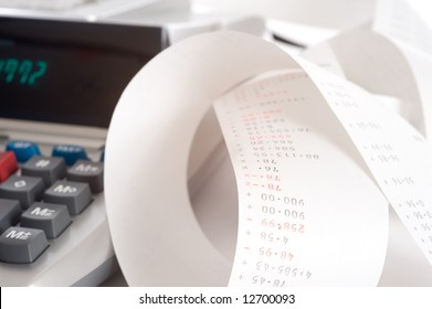 An Adding Machine Or Calculator With Adding Machine Tape Or Paper.