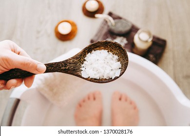 Adding Magnesium Chloride vitamin salt in foot bath water, solution. Magnesium grains in foot bath water are ideal for replenishing the body with this essential mineral, promoting overall well being.