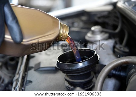 adding oil to the car engine