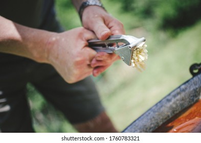 Adding Pressed Garlic Into Goulash Soup On The Garden Party.