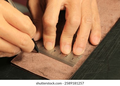 Adding stitching lines in leathercraft.