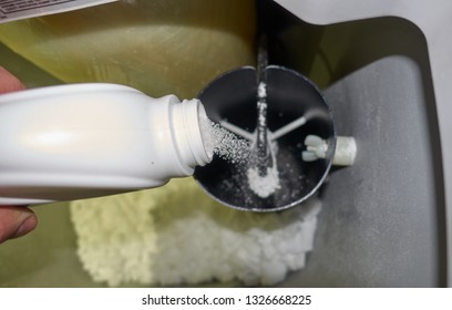 adding water softener cleaner to brine tank                              