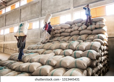 Addis Ababa, Ethiopia - January 30 2014: Men stacking large bags of coffee beans in a warehouse