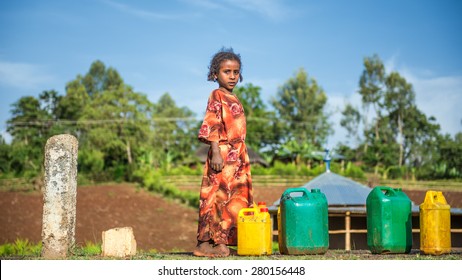 ADDIS ABBABA, ETHIOPIA - MAY 1, 2015 : Young ethiopian girl going for water near Addis Ababa.