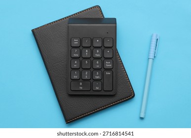 Additional mini keyboard and notebook on red background. Office accessories