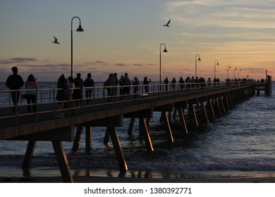 ADELAIDE - APR 23 2019:Silhouette Of People Walking On Glenelg Jetty A Very Popular Tourist Attraction And Sightseeing In Adelaide The Capital City Of South Australia.