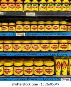 Adelaide, South Australia, November 8th 2019: supermarket shelving in Australia with iconic spread Vegemite jars and tubes