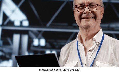 Adept IT professional navigating network of servers in industrial workspace, engineer with laptop in hand ensuring seamless operations, doing optimizations and maintenance in data center
