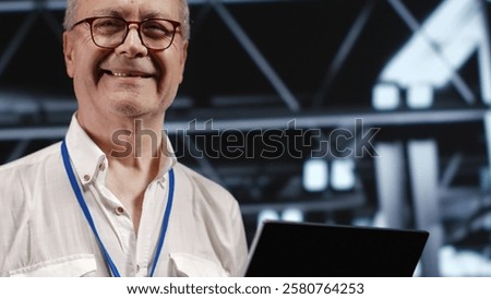 Adept IT professional navigating network of servers in industrial workspace. Engineer with laptop in hand ensuring seamless operations, doing optimizations and maintenance in data center